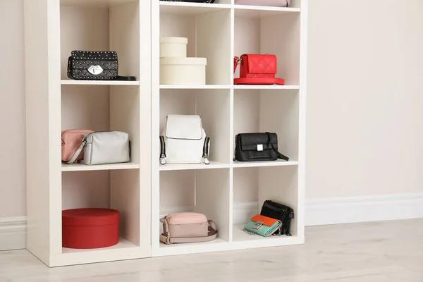 Wardrobe shelves with different stylish bags indoors. Idea for interior design