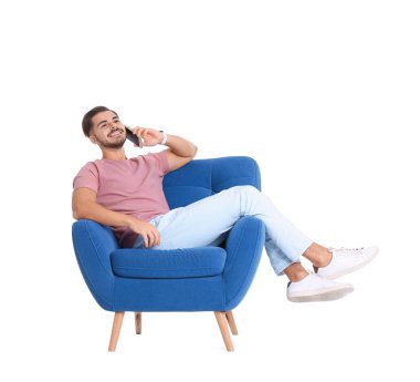 Koltuk beyaz arka plan karşı telefonda konuşurken yakışıklı genç