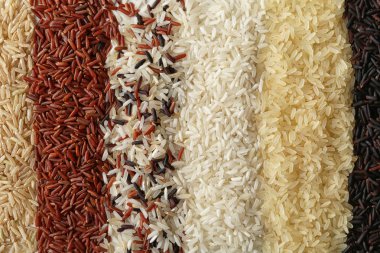 Brown and other types of rice as background, closeup clipart