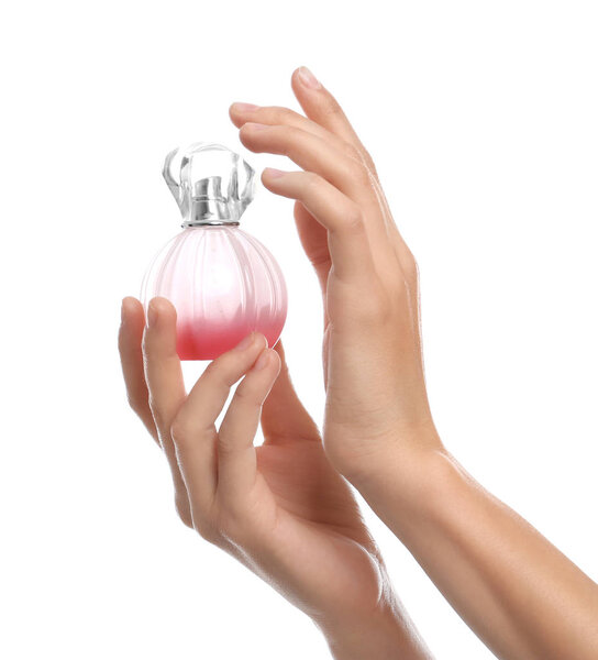 Young woman with perfume bottle on white background, closeup