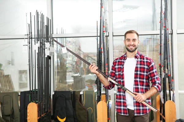 Man Choosing Fishing Rod Sports Shop Space Text — Stock Photo, Image