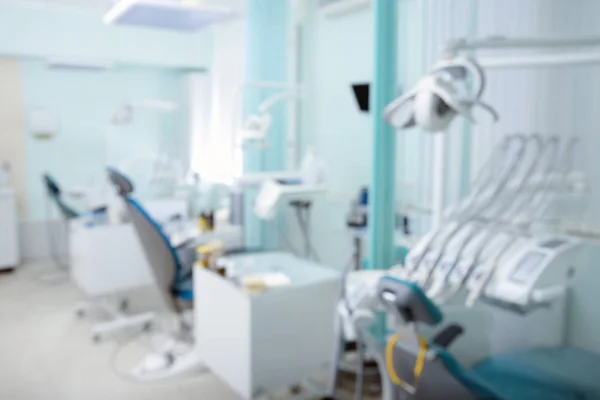 Blurred view of dentist office with chairs and professional equipment