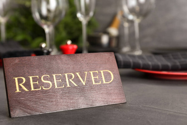 Накрытие стола с табличкой RESERVED в ресторане
