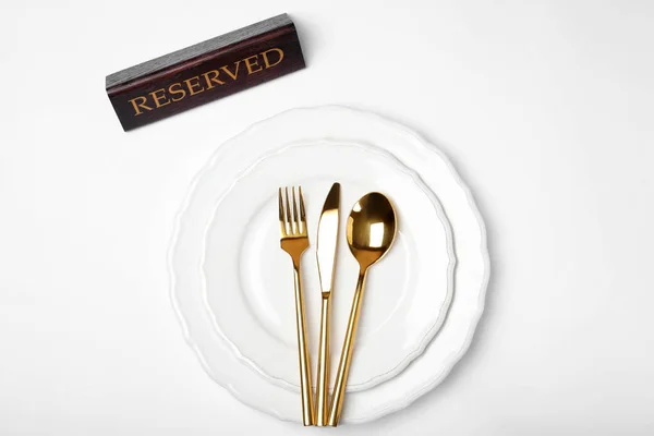 Elegant Table Setting Reserved Sign White Background Top View — Stock Photo, Image