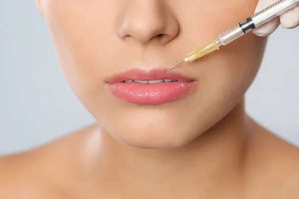 Young Woman Getting Lips Injection Grey Background Closeup Cosmetic Surgery — Stock Photo, Image