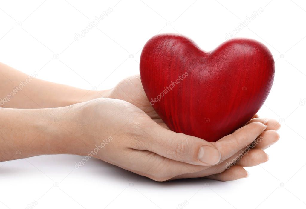 Woman holding red heart on white background, closeup. Cardiology concept