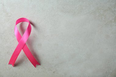 Pembe kurdele ve gri arka plan, üstten görünüm üzerinde metin için yer. Meme kanseri bilinçlendirme kavramı