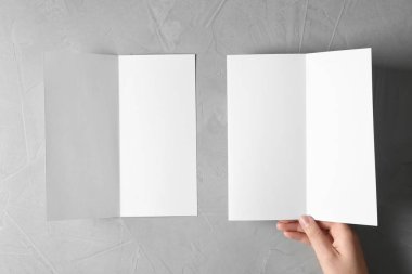 Gri arka plan, üstten görünüm üzerinde boş broşür kadınla. Mockup tasarım için