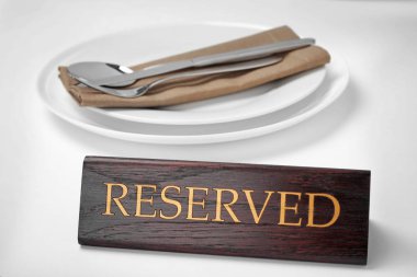 Elegant table setting and RESERVED sign in restaurant clipart