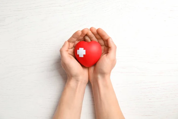 Man Holding Red Heart Adhesive Plasters Wooden Background Top View — Stock Photo, Image