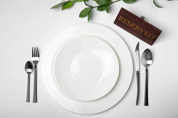 Elegant Table Setting Reserved Sign White Background Top View — Stock Photo, Image