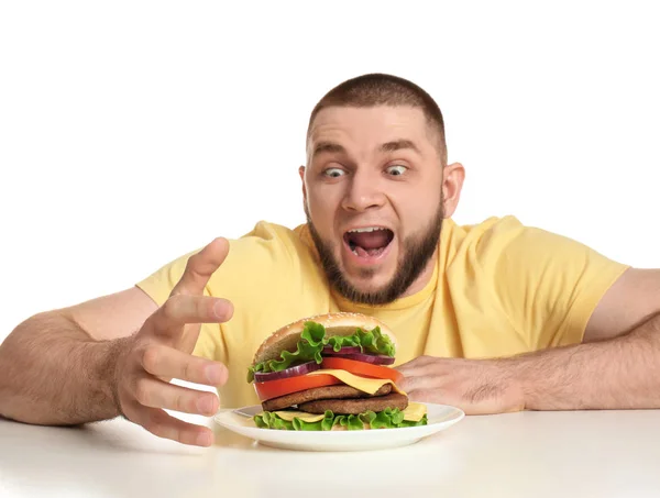 Jeune Homme Affamé Hamburger Savoureux Sur Fond Blanc — Photo