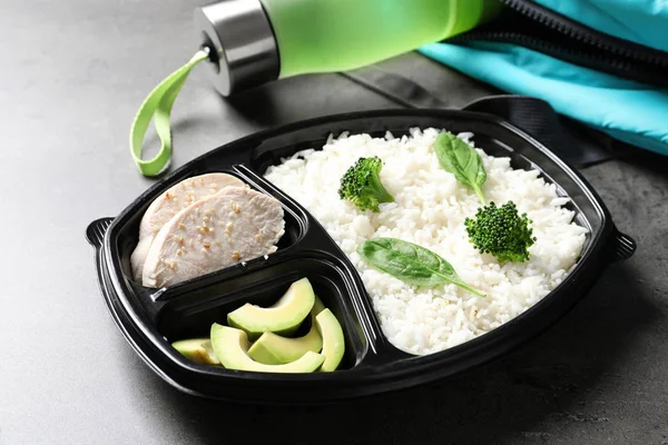 Container with natural protein food on gray table