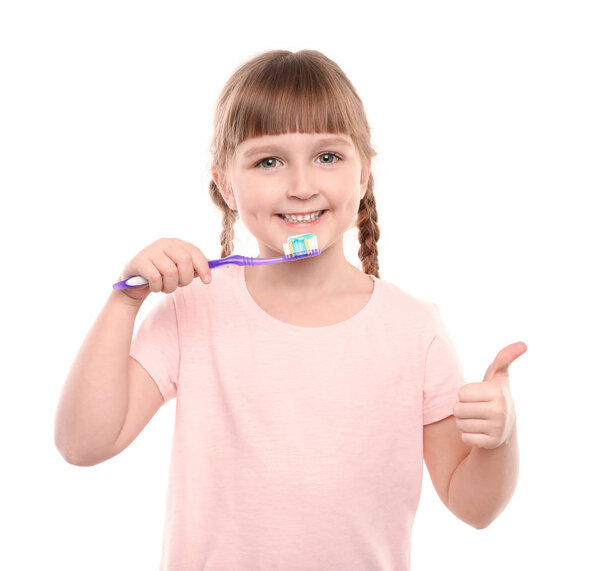 Little girl brushing teeth on color background