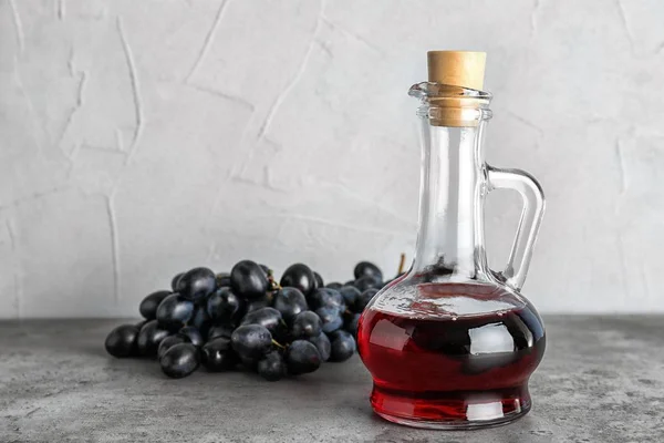 Glass Jug Wine Vinegar Fresh Grapes Gray Table — Stock Photo, Image