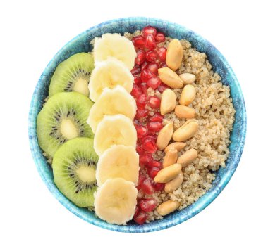 Quinoa yulaf lapası fıstık, kivi, muz ve nar tohumları üzerinde beyaz arka plan, üstten görünüm ile kase
