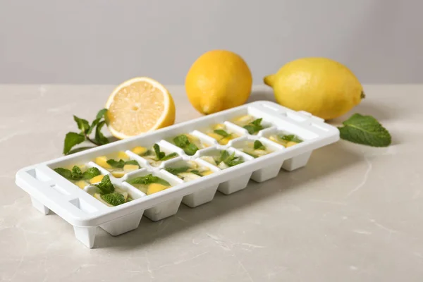 Bandeja Cubo Hielo Con Menta Limón Agua Sobre Mesa Gris —  Fotos de Stock