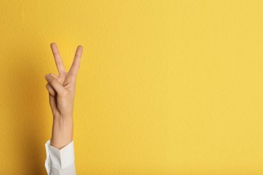 Zafer jest renk arka plan üzerinde gösterilen genç kadın. Metin için yer
