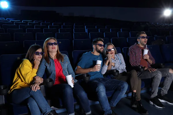 Young people watching movie in cinema theatre