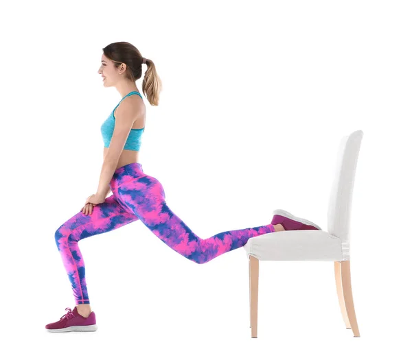 Young woman exercising with chair on white background. Home fitness