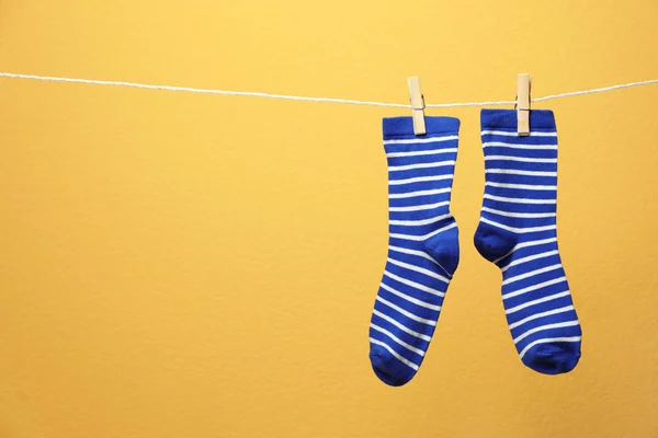 stock image Cute socks on laundry line against color background. Space for text