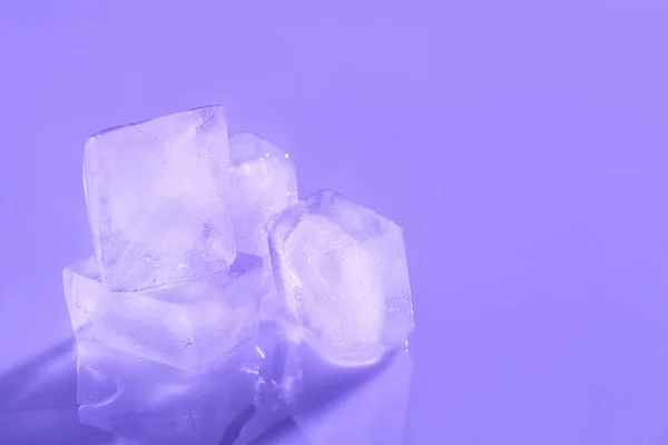 Ice cubes on color background. Space for text