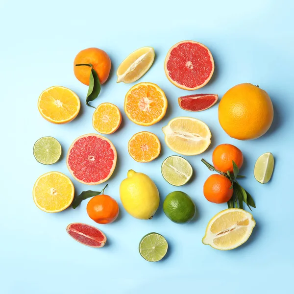 Different citrus fruits on color background, flat lay