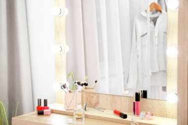 Soyunma odasında beyaz duvarının yakınında masada makyaj aynası