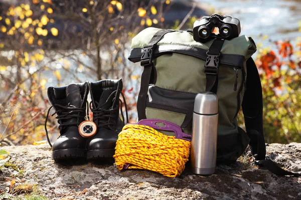 Set of camping equipment on ground outdoors