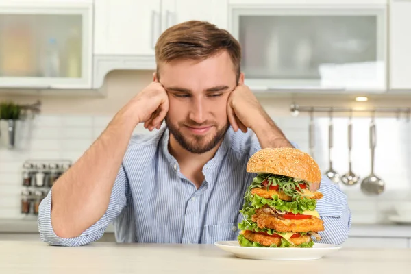 Young Man Huge Burger Table Kitchen — Stock Photo, Image