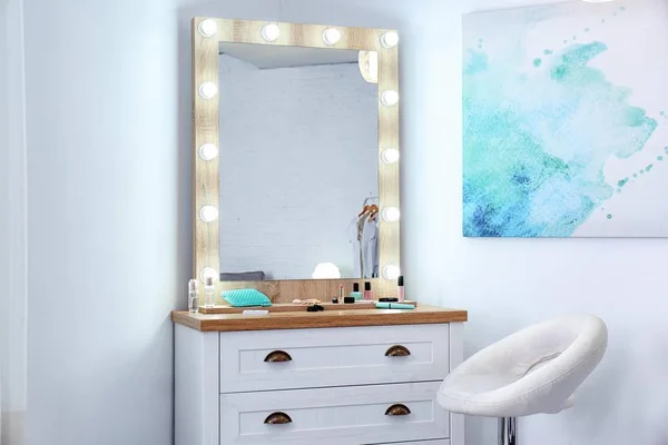 Dressing room interior with makeup mirror and table
