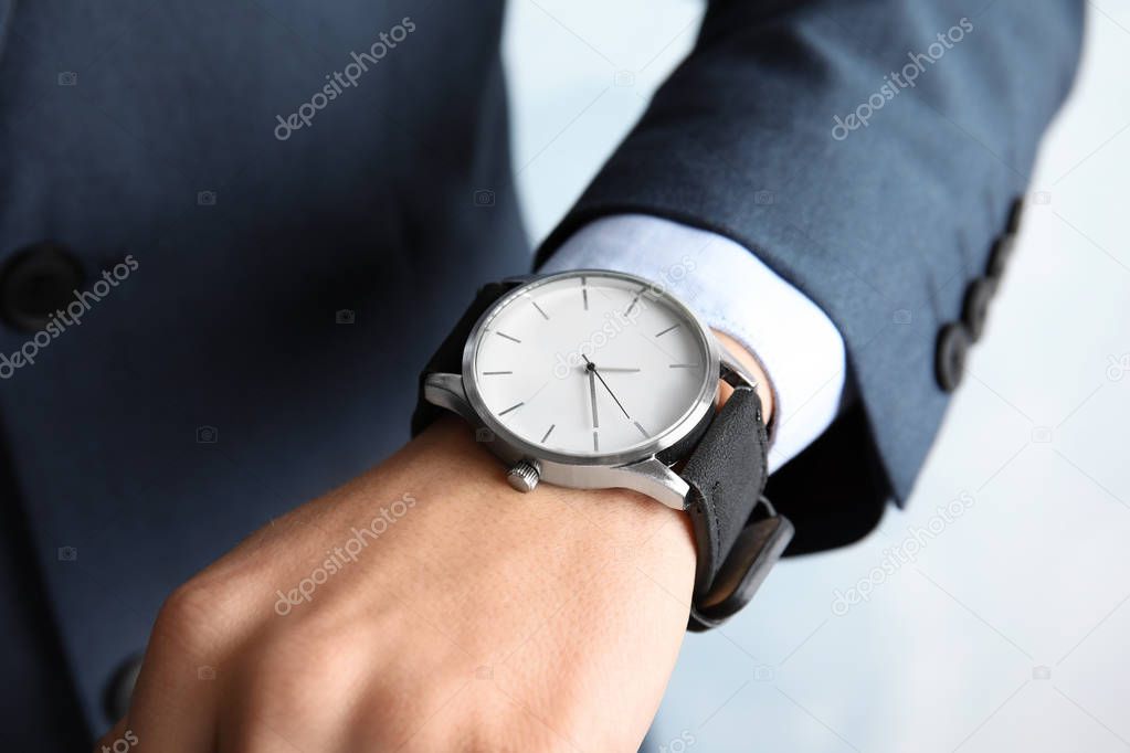 Businessman with stylish wrist watch, closeup. Time management