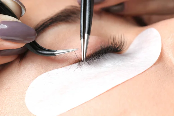 Young woman with beautiful natural eyelashes, closeup view