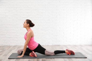 Beyaz arka plan üzerinde egzersiz yaparak dumbbells ile genç güzel kadın. Ev fitness