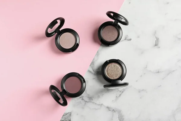 Flat lay composition with eye shadows on table