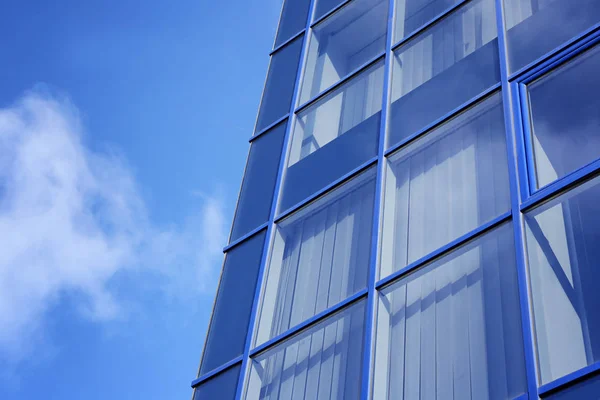 Modern office building with tinted windows against blue sky