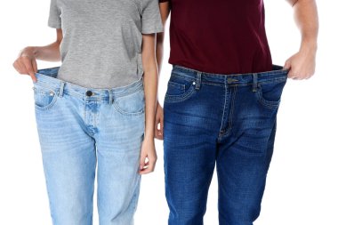 Beyaz arka planda, closeup büyük boy kot pantolon insanların uygun. Kilo kaybı