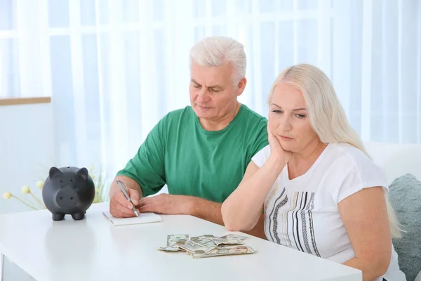 Mature Couple Money Piggy Bank Table — Stock Photo, Image