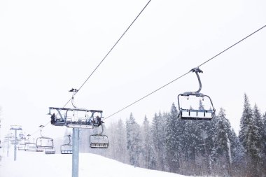 Ski lift at snowy mountain resort. Winter vacation