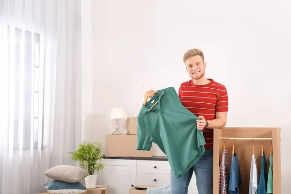 Young couple near wardrobe boxes at home