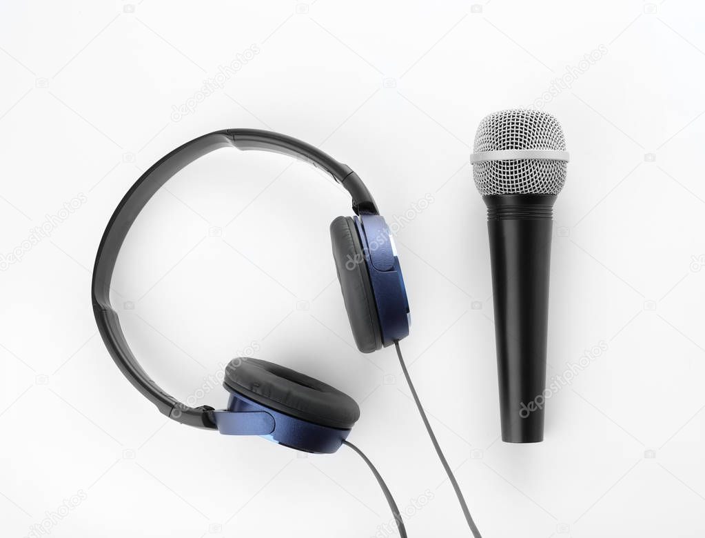 Microphone with headphones on white background, top view