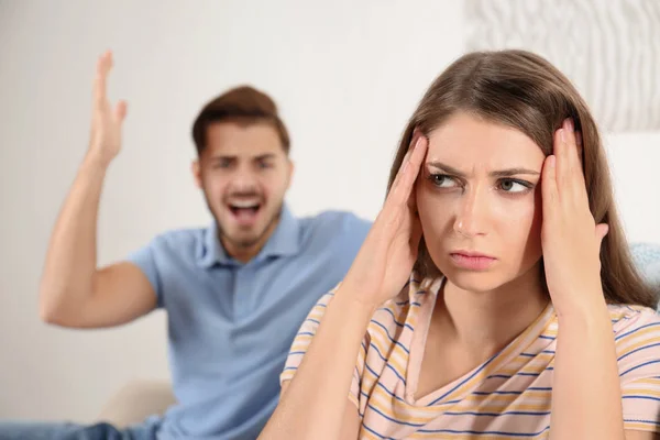 Young couple arguing in living room. Relationship problems