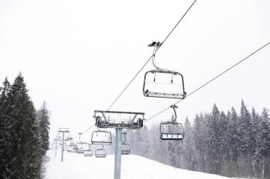 Ski lift at snowy mountain resort. Winter vacation