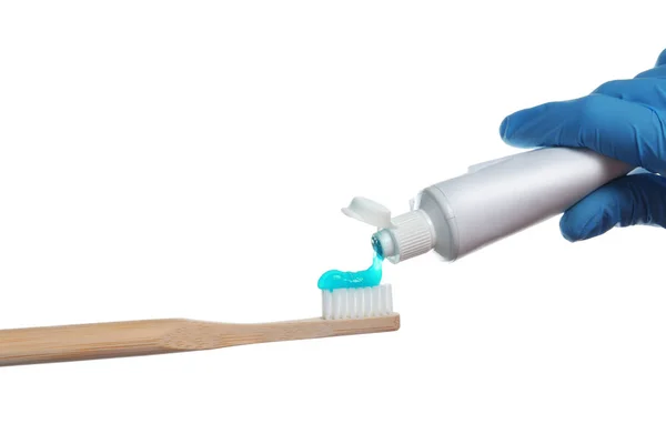 Dentist Squeezing Paste Toothbrush White Background — Zdjęcie stockowe