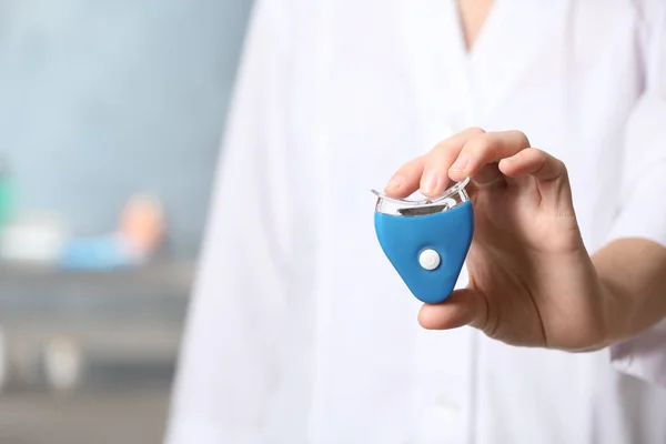 Female Dentist Holding Teeth Whitening Device Blurred Background Space Text — Stock Fotó