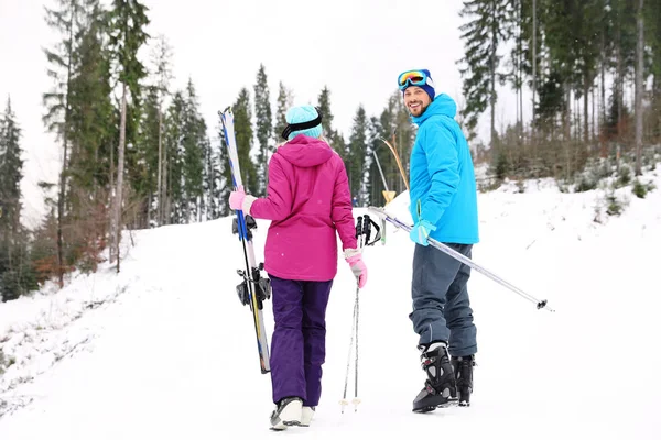 幸福的夫妇与滑雪设备坐在雪山雪山 文字的空间 — 图库照片