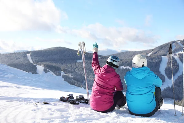 Happy Couple Ski Equipment Sitting Snowy Hill Mountains Space Text — ストック写真