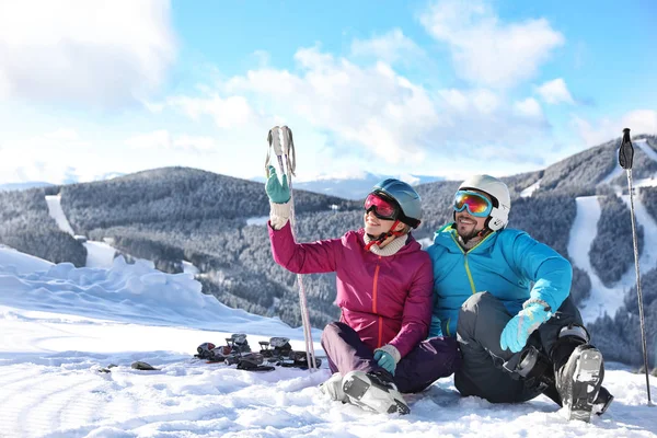 Happy Couple Ski Equipment Sitting Snowy Hill Mountains Space Text — ストック写真