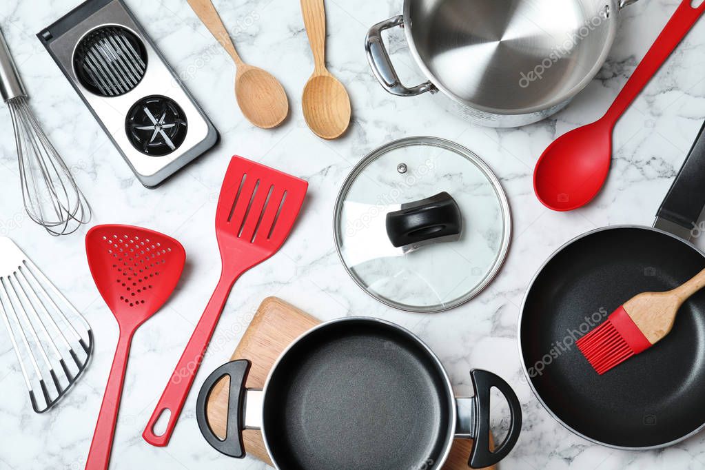 Flat lay composition with clean cookware on marble background