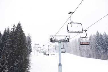 Ski lift at snowy mountain resort. Winter vacation